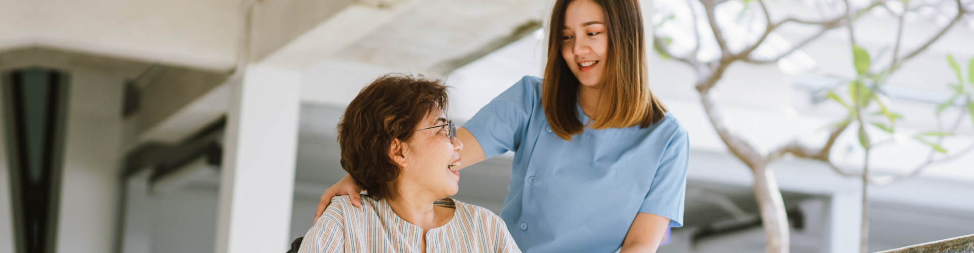 caregiver attending to elderly woman on wheelchair