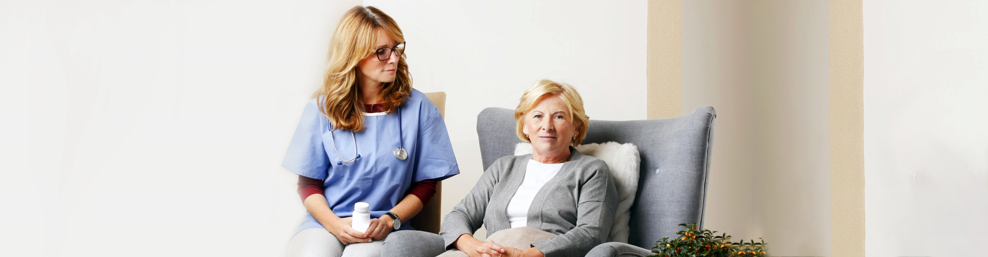 nurse attending to an elderly woman